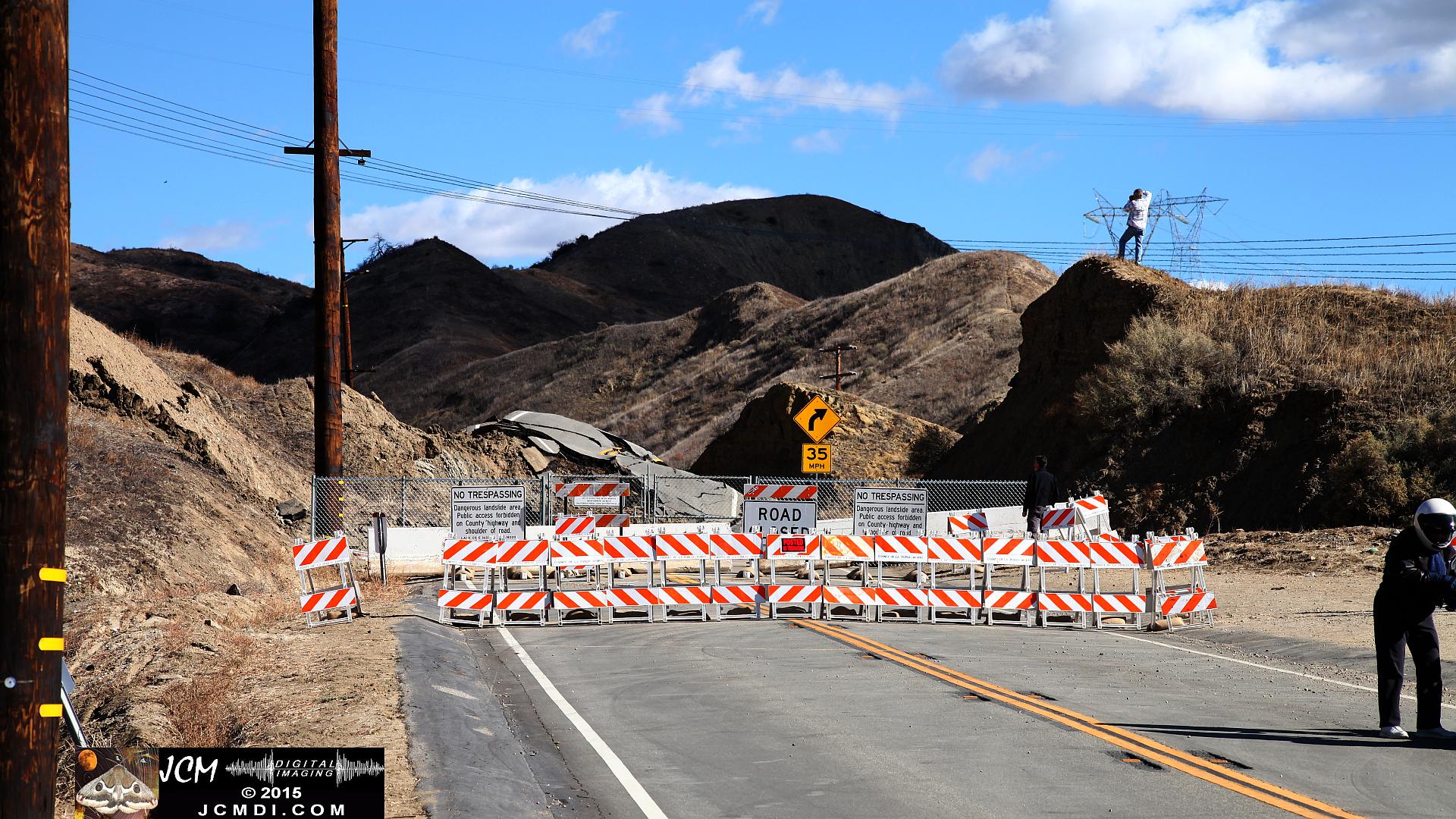 Landslide, buckled pavement, and terrain at Vasquez Canyon Road in Santa Clarita, CA filmed 11-25-2015